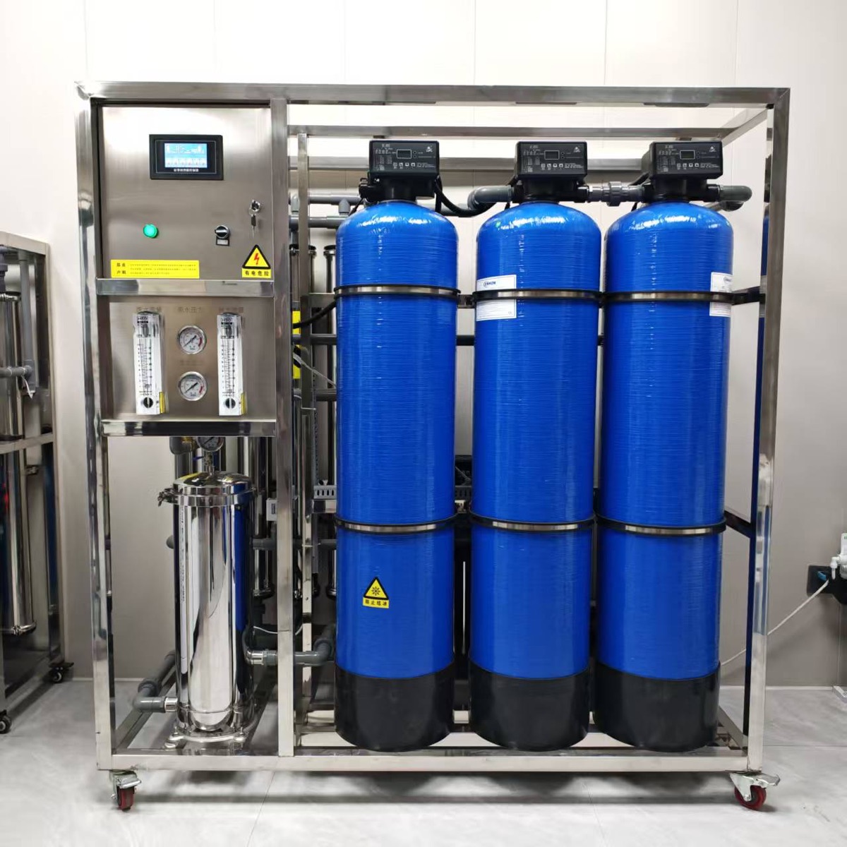 industrial RO machine with three blue FRP tanks and stainless steel frame